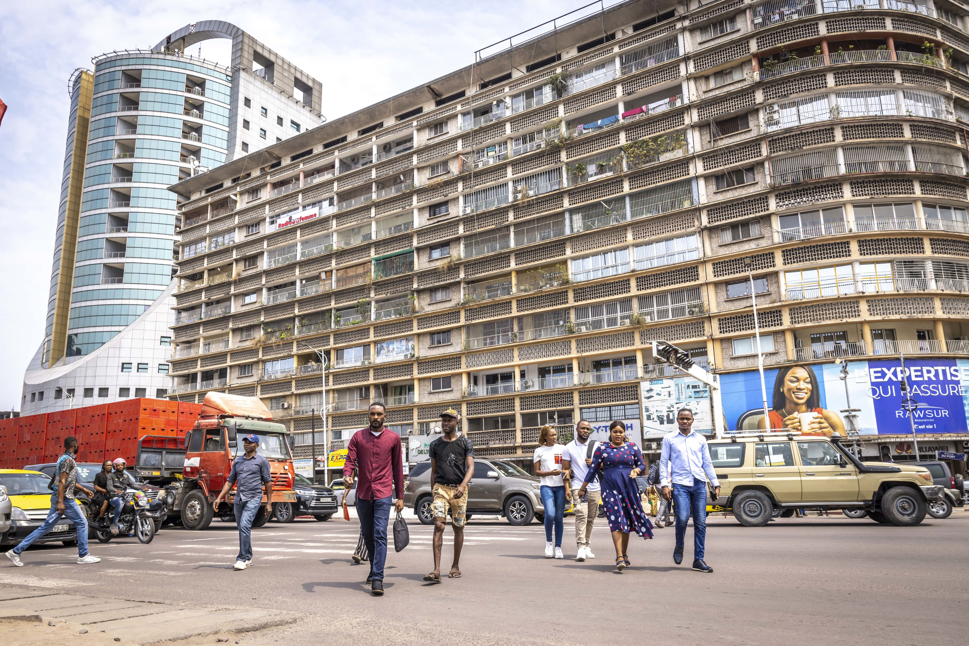 Dwellers cross a main boulevard in Kinshasa's Gombe municipality