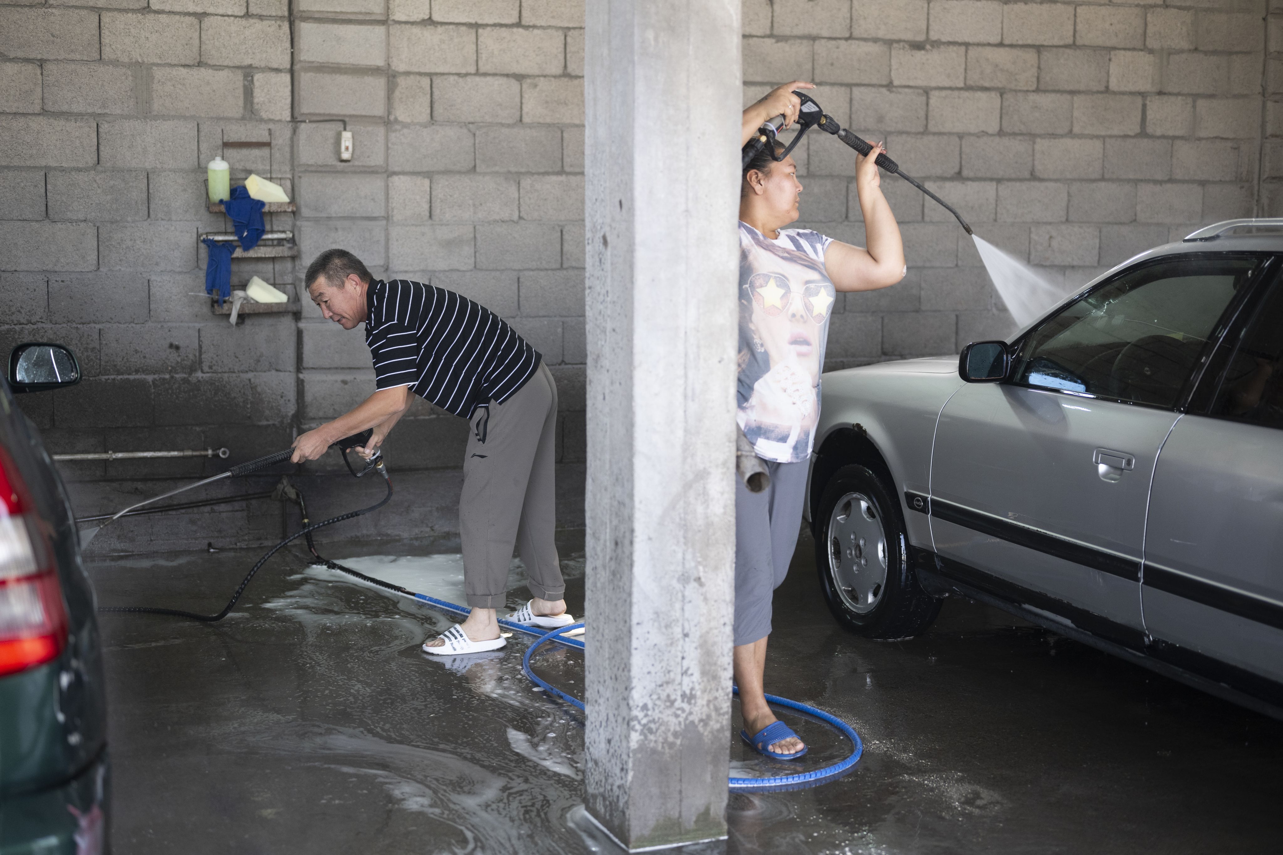 Workers at Gulbaira Botaliyeva's carwash shop.